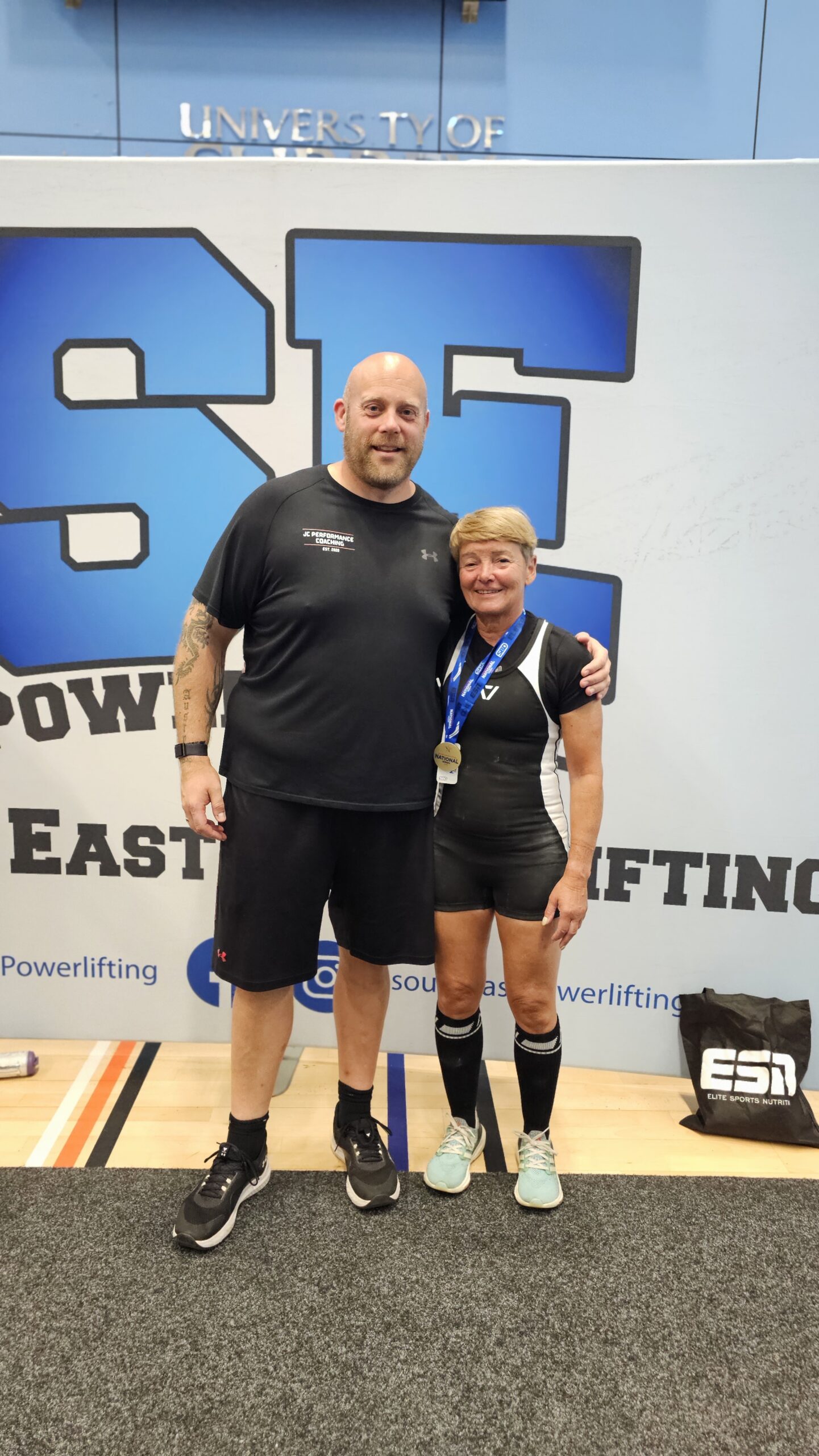 Strength athlete posing with her JC Performance strength coach