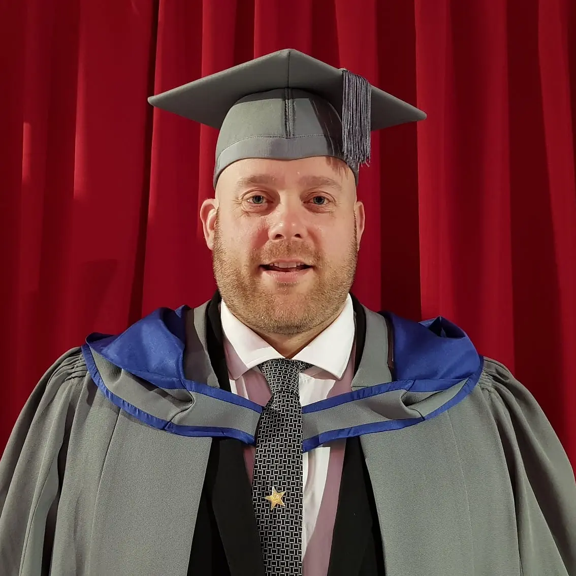 MSc Sport and Exercise Psychology student wearing a graduation cap and gown