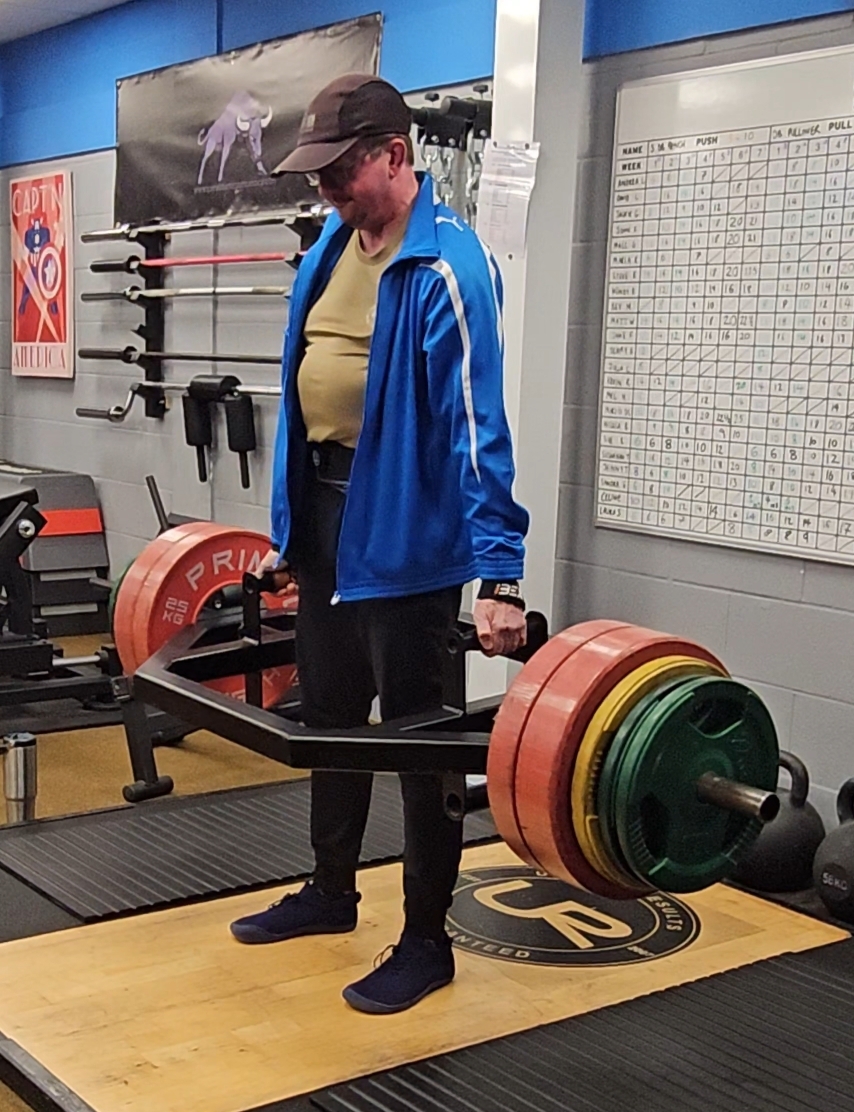 Strength athlete performing a barbell lift during training
